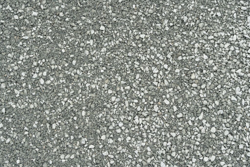 A closeup of a gravel surface that contains a wide variety of sizes, from 5/8