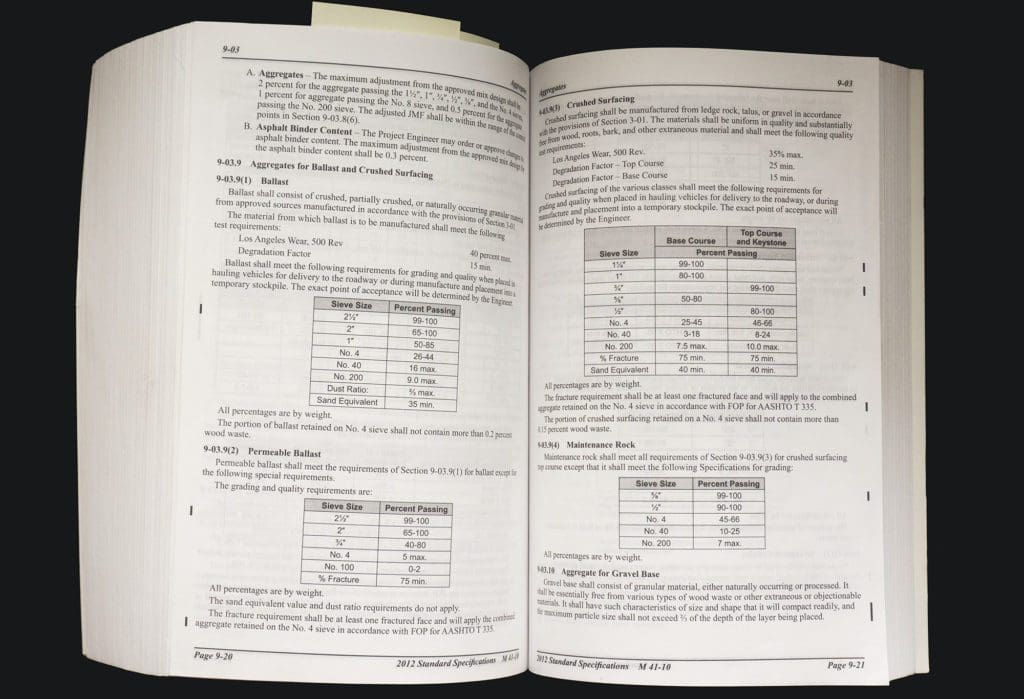 a book lying open on a table shows information and charts with numbers