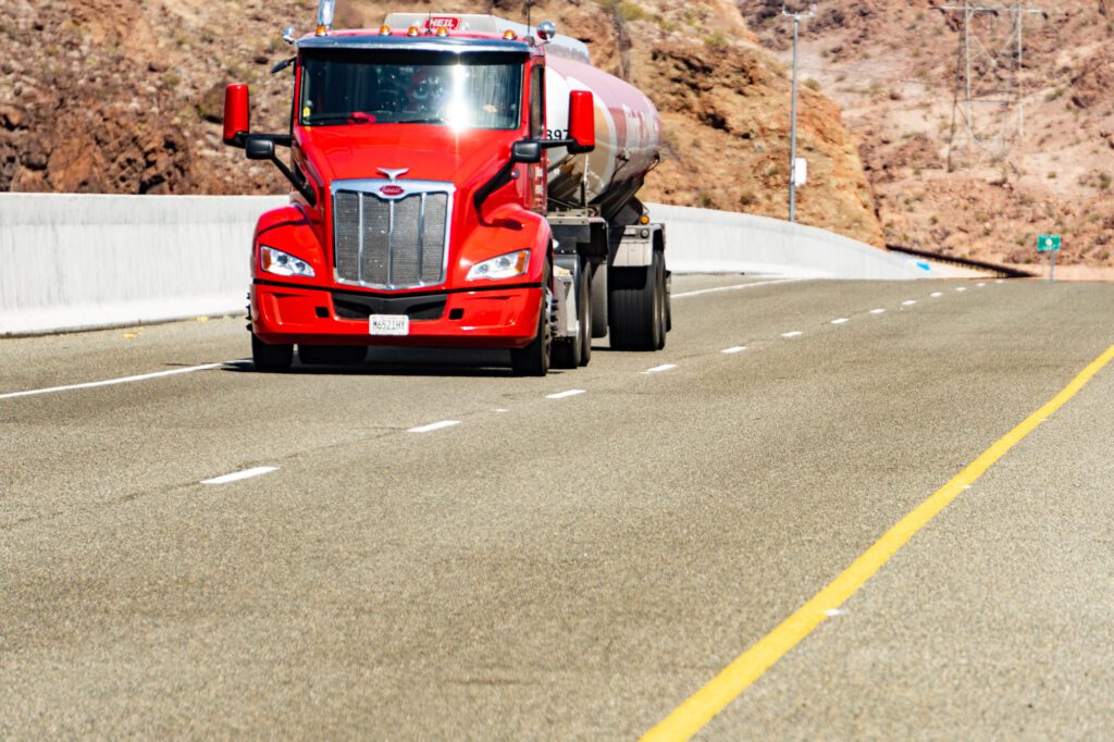 semi truck driving on a roadway that has an epoxy polymer-Armorstone treatment