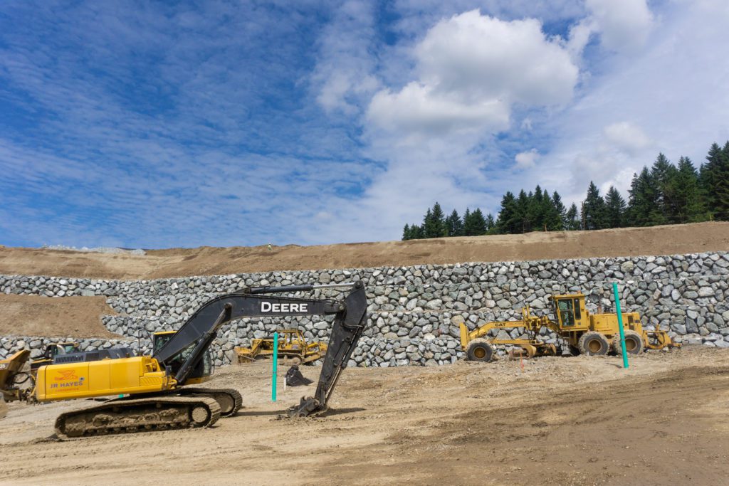 tiered rock wall with construction equipment