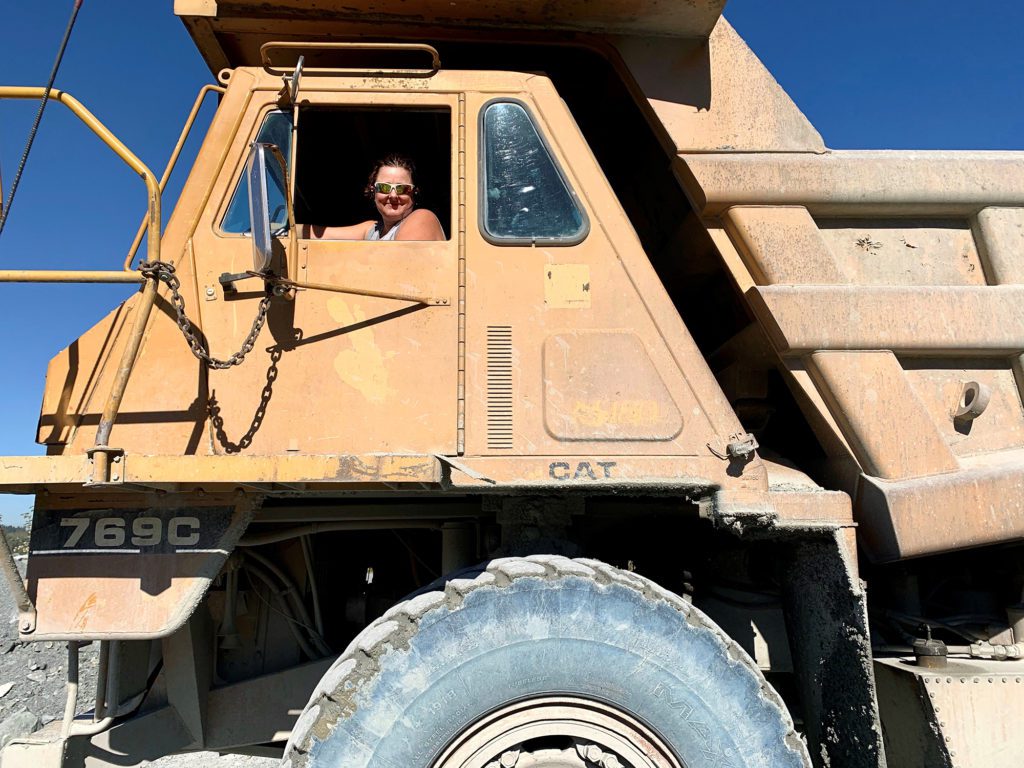 woman in cab of rock truck