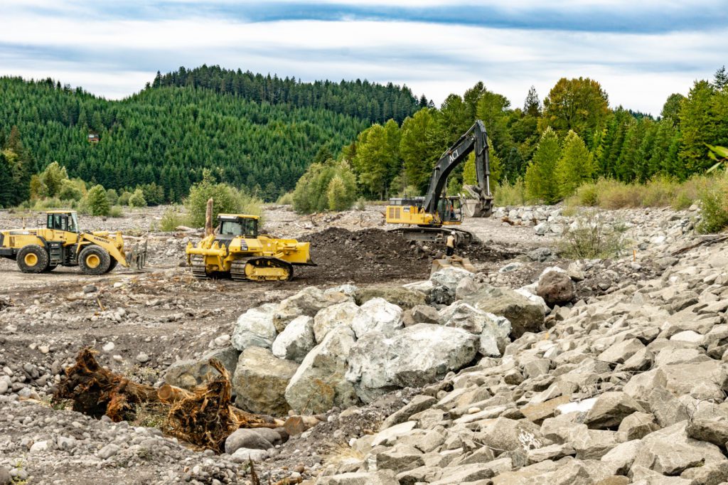 construction equipment working on rock installations next to the Nisqually River levee