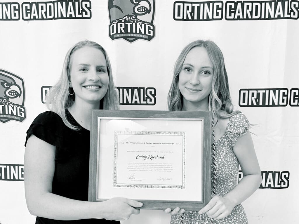 Eve Hart presents a scholarship certificate to winner Emilly Kneeland
