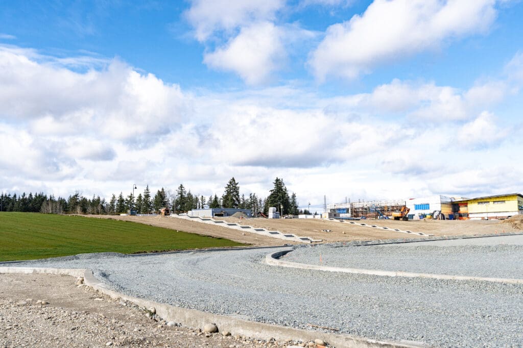crushed rock being used as to build the base of a running track