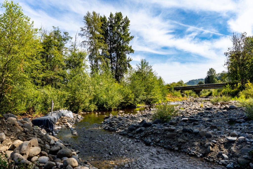 A diverted river meanders peacefully around a bend in the river.